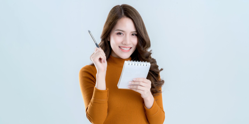 girl with a small notebook and pen